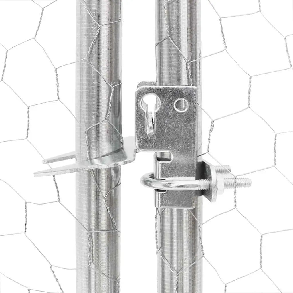 Close-up of lockable metal latch on galvanised steel dog run door with hexagonal mesh