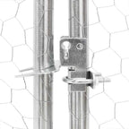 Close-up of lockable metal latch on galvanised steel dog run door with hexagonal mesh