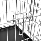 Close-up of metal door latch mechanism on galvanised steel dog crate
